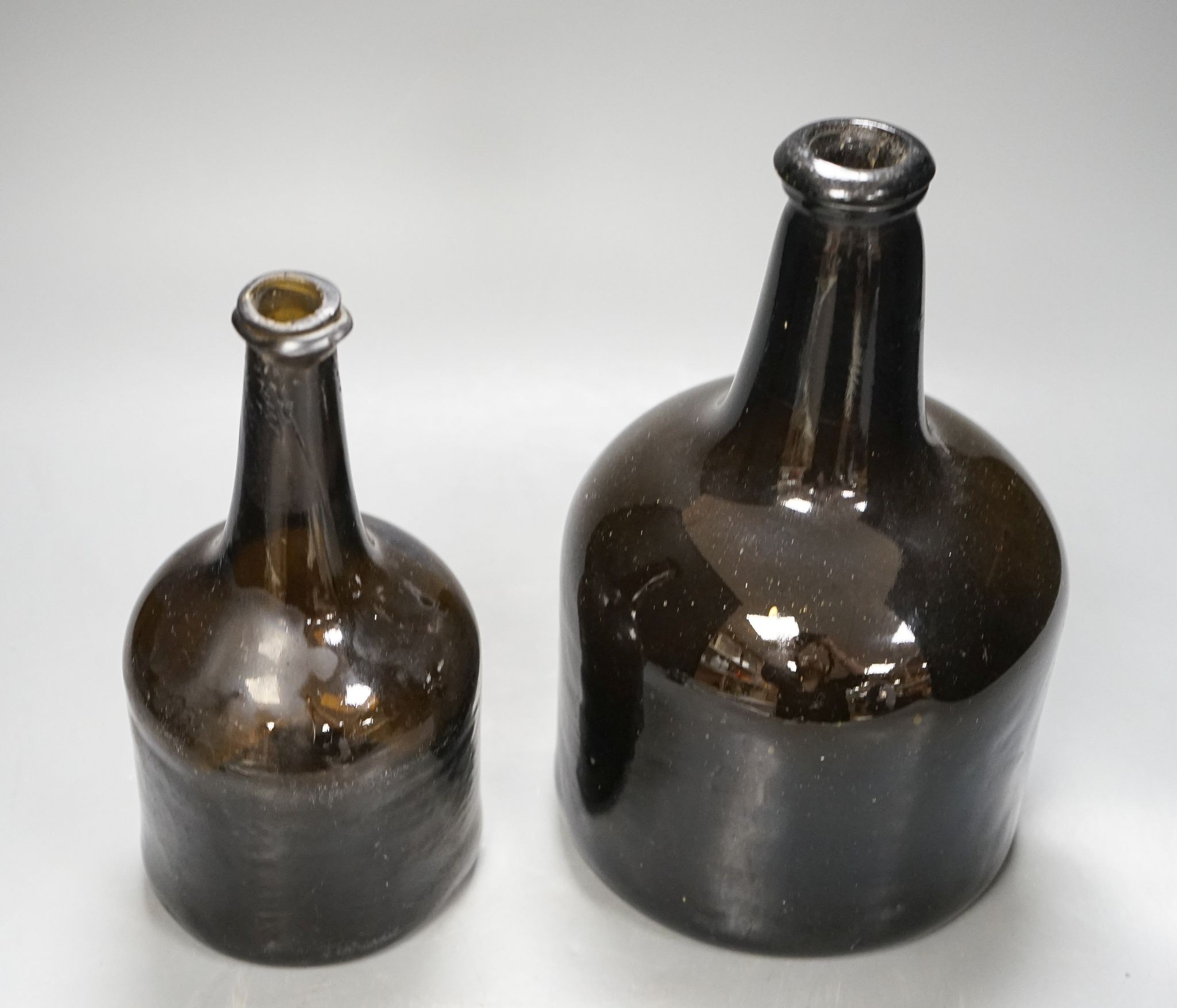 Two mid 18th century glass mallet-shape wine bottles, tallest 27cm